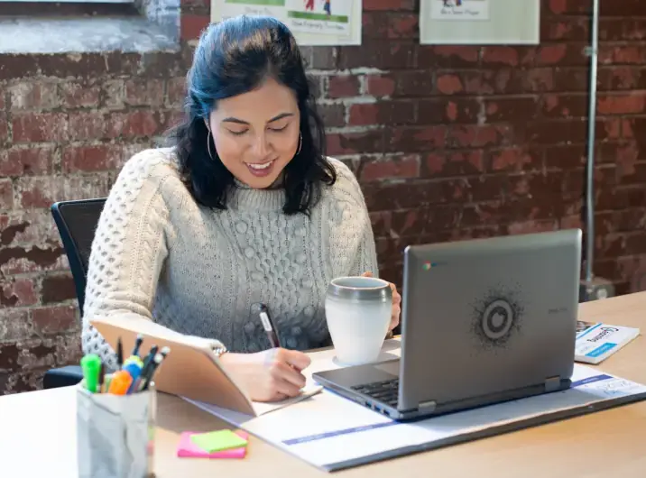 Woman at a desk using a laptop computer