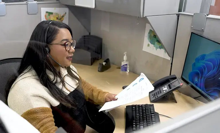 Woman wearing a phone headset speaking to a customer